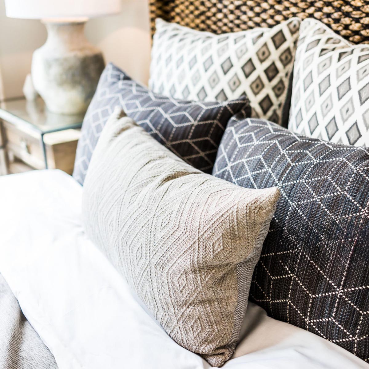 Closeup of new bed comforter with decorative pillows